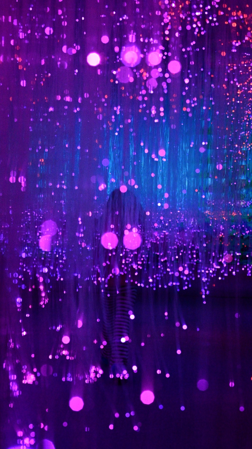 Child moving through purple points of light